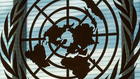 Photo: logo of the United Nations in front of a window